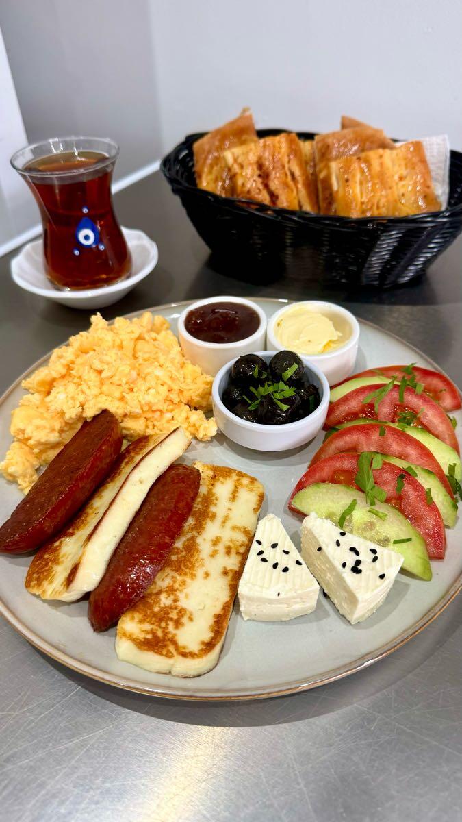 Fratello Turkish breakfast: eggs, grilled halloumi, sujuk, feta, olives, tomatoes and cucumber with Turkish tea