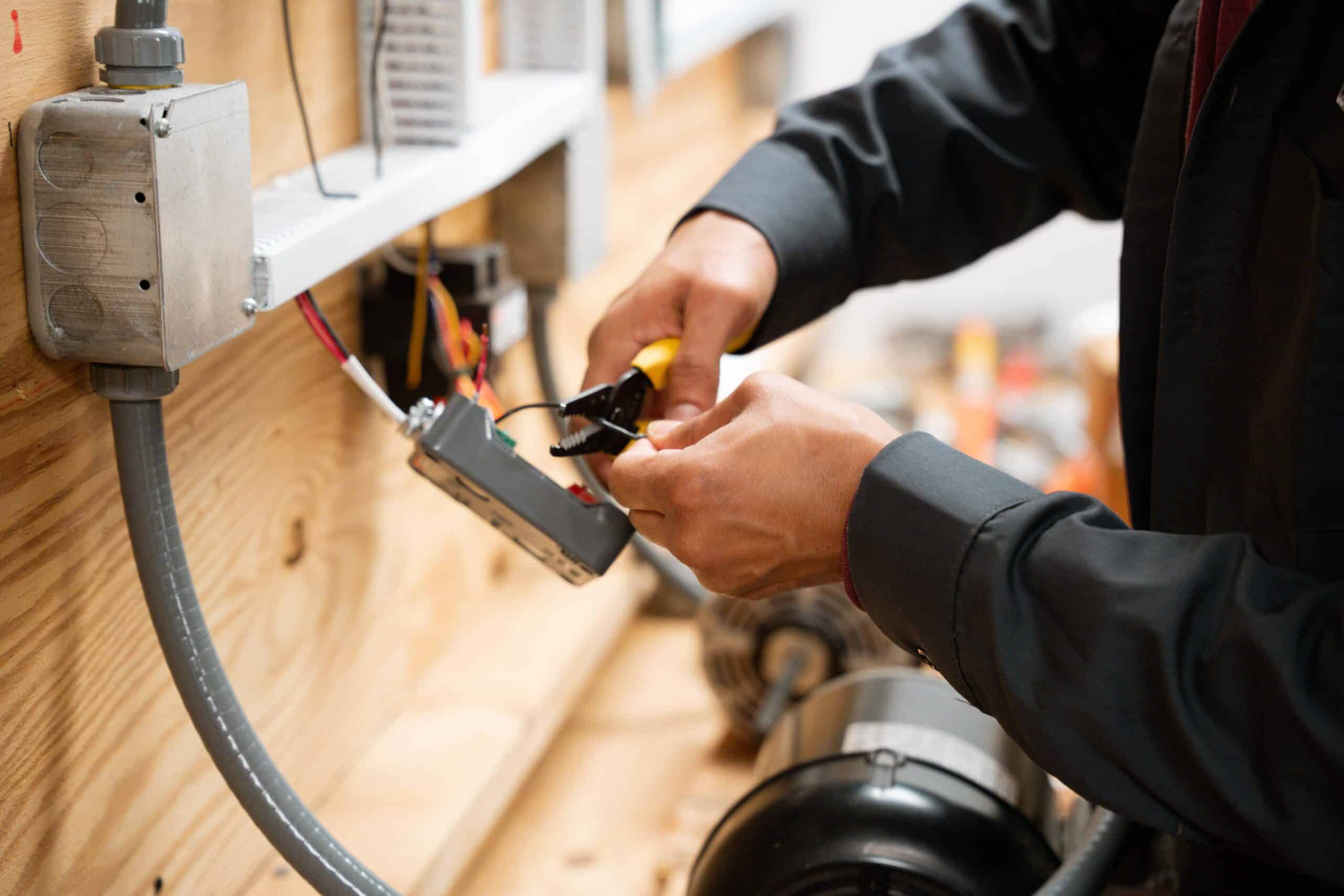 Professional houma electrician wiring an electrical junction box
