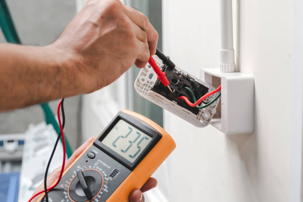 Electrician testing a circuit with a multimeter to verify it is safe