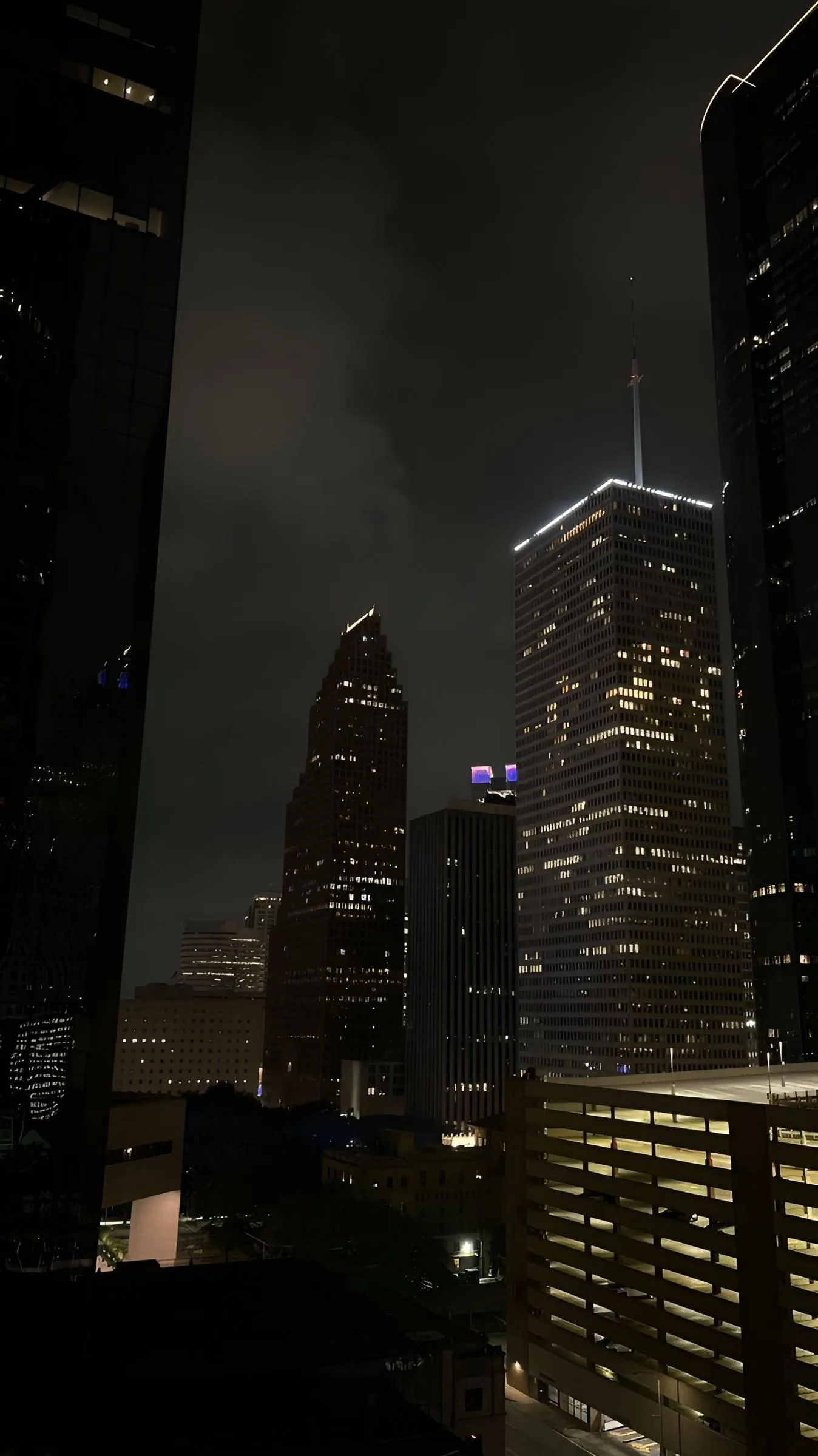 City Skyscrapers Lit Up in a Stormy Night Scene Wallpaper