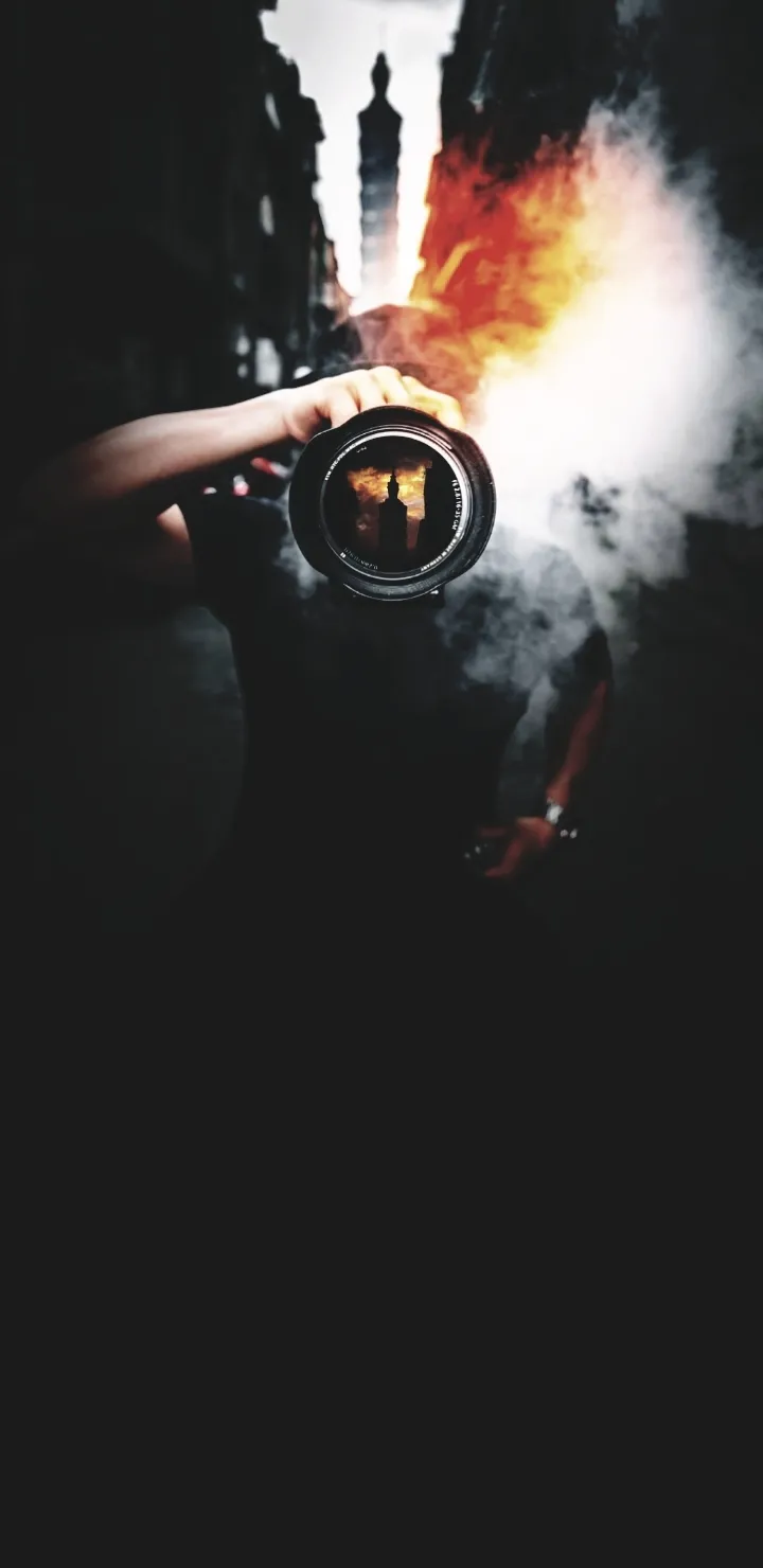 Photographer Holding Camera in Dark Creative Mood Wallpaper