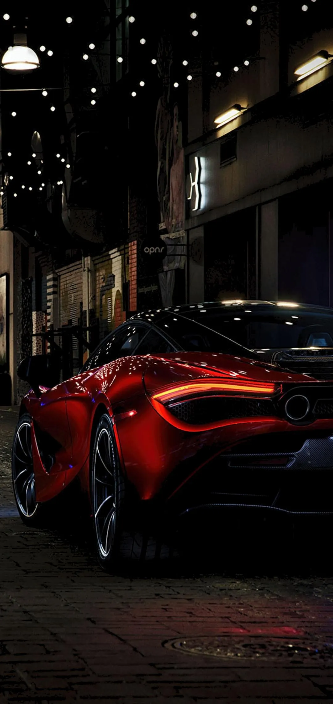 Red Supercar Parked on Dark City Street at Night Wallpaper