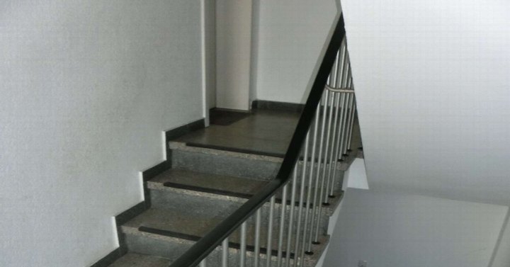 Treppenhaus mit Betonstufen und Metallgeländer in einer Eigentumswohnung in Sankt Augustin