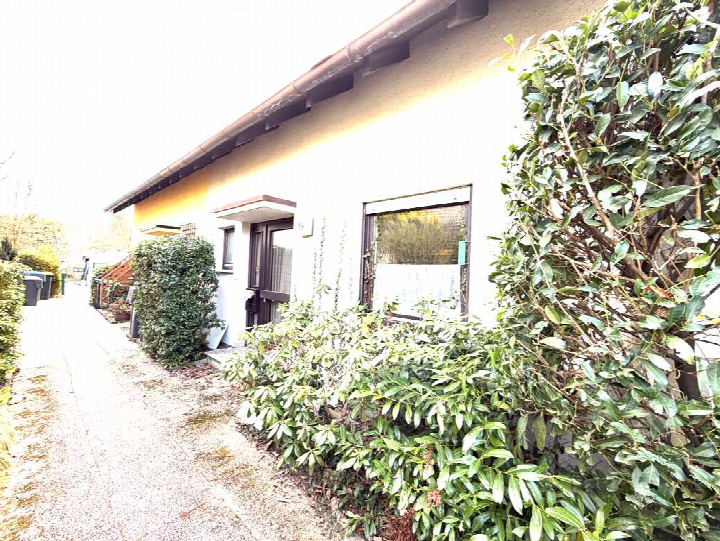 Seitenansicht eines Gebäudes mit Fenstern, Tür und grüner Umgebung in Enzianstraße 19, Bad Salzuflen