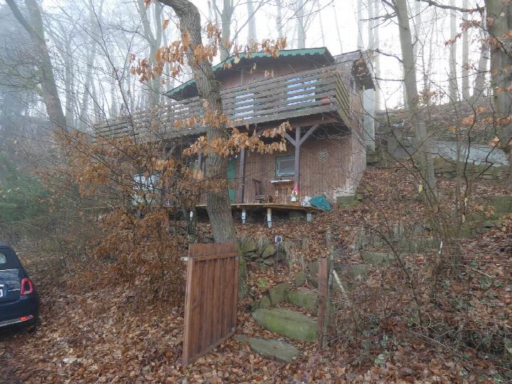 Holzgebäude im Wald mit Laub am Boden, Steinweg und Tor; Uferstraße 28, Guxhagen
