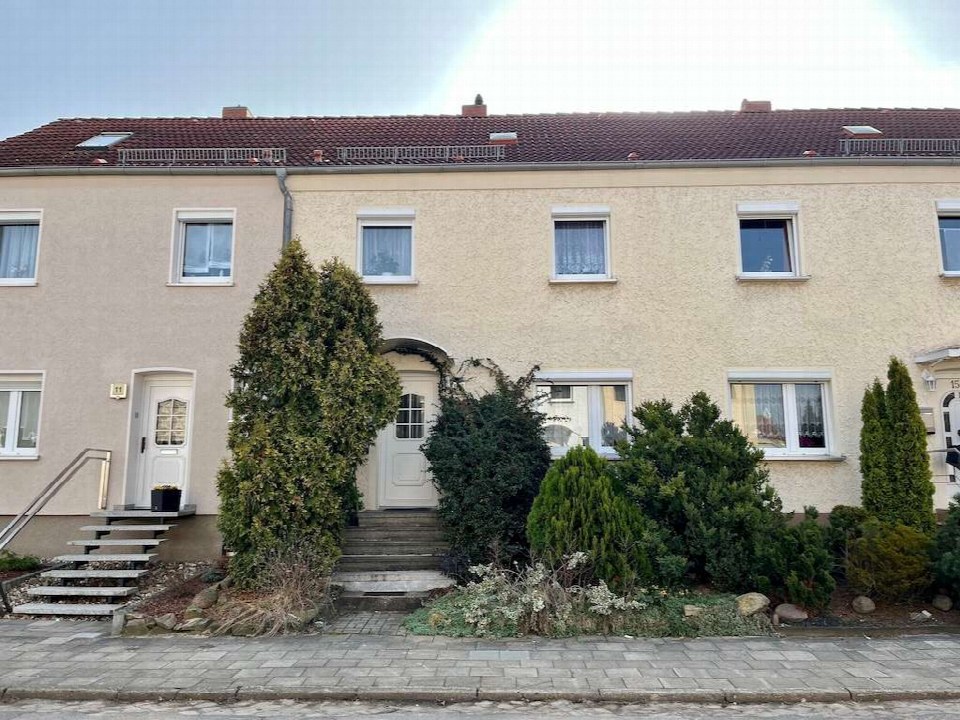 Vorderansicht eines zweistöckigen Wohnhauses mit Eingang, Fenstern, Dach und Vorgarten in Schönebeck, Dr.-Külz-Straße 13