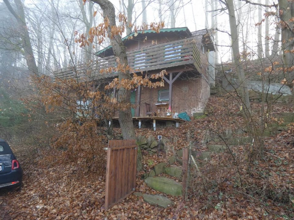 Holzgebäude im Wald mit Laub am Boden, Steinweg und Tor; Uferstraße 28, Guxhagen