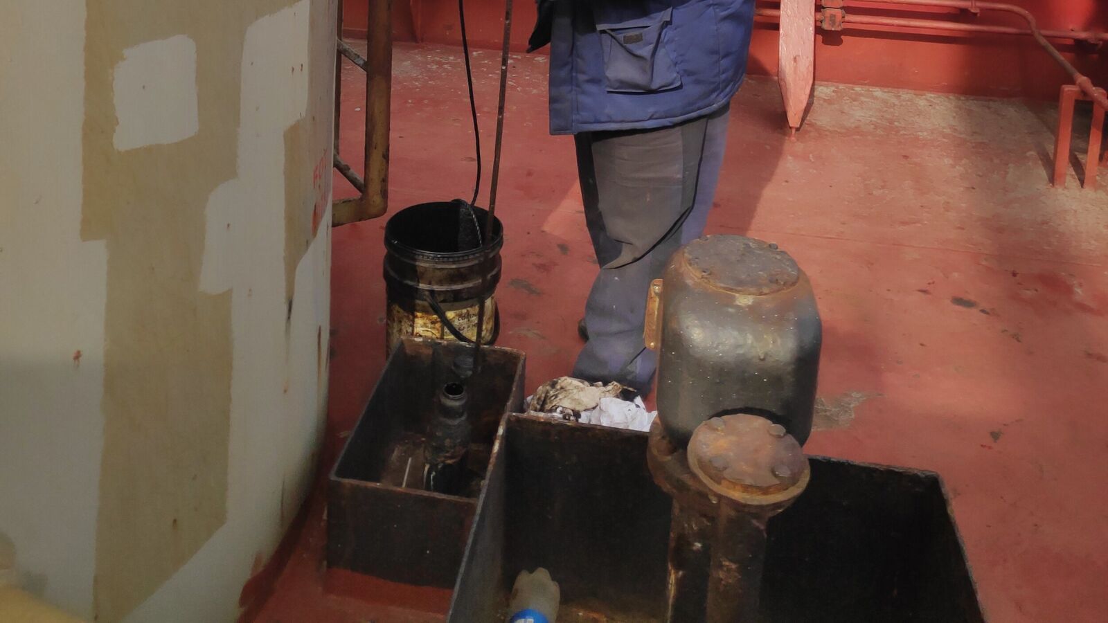 Taking soundings of the main deck fuel oil tank with a measuring stick