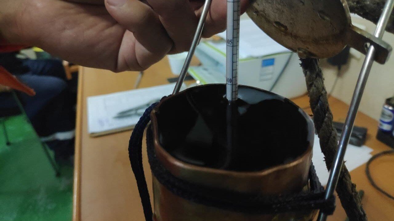 Hydrometer in the sampling bucket, checking sea water density