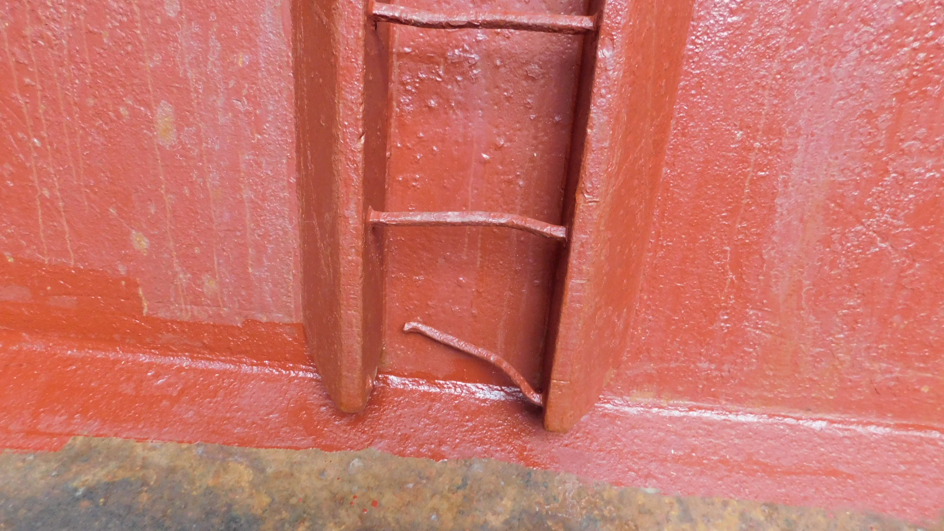 Hold bulkhead, note torn off step of vertical ladder