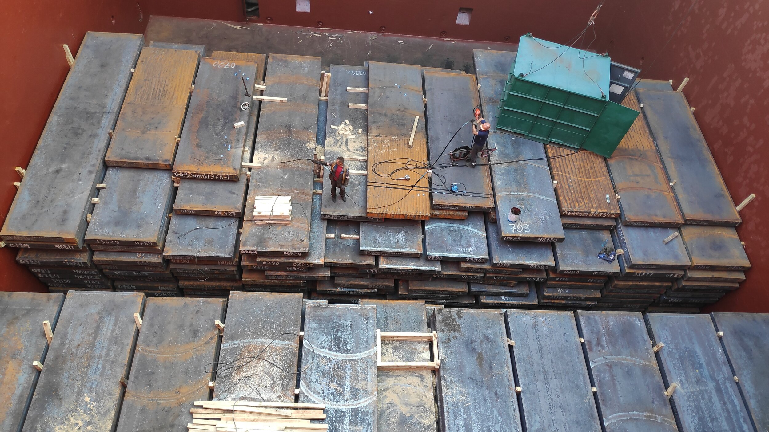 Steel slabs loaded in hold, chocking by timbers of top layer