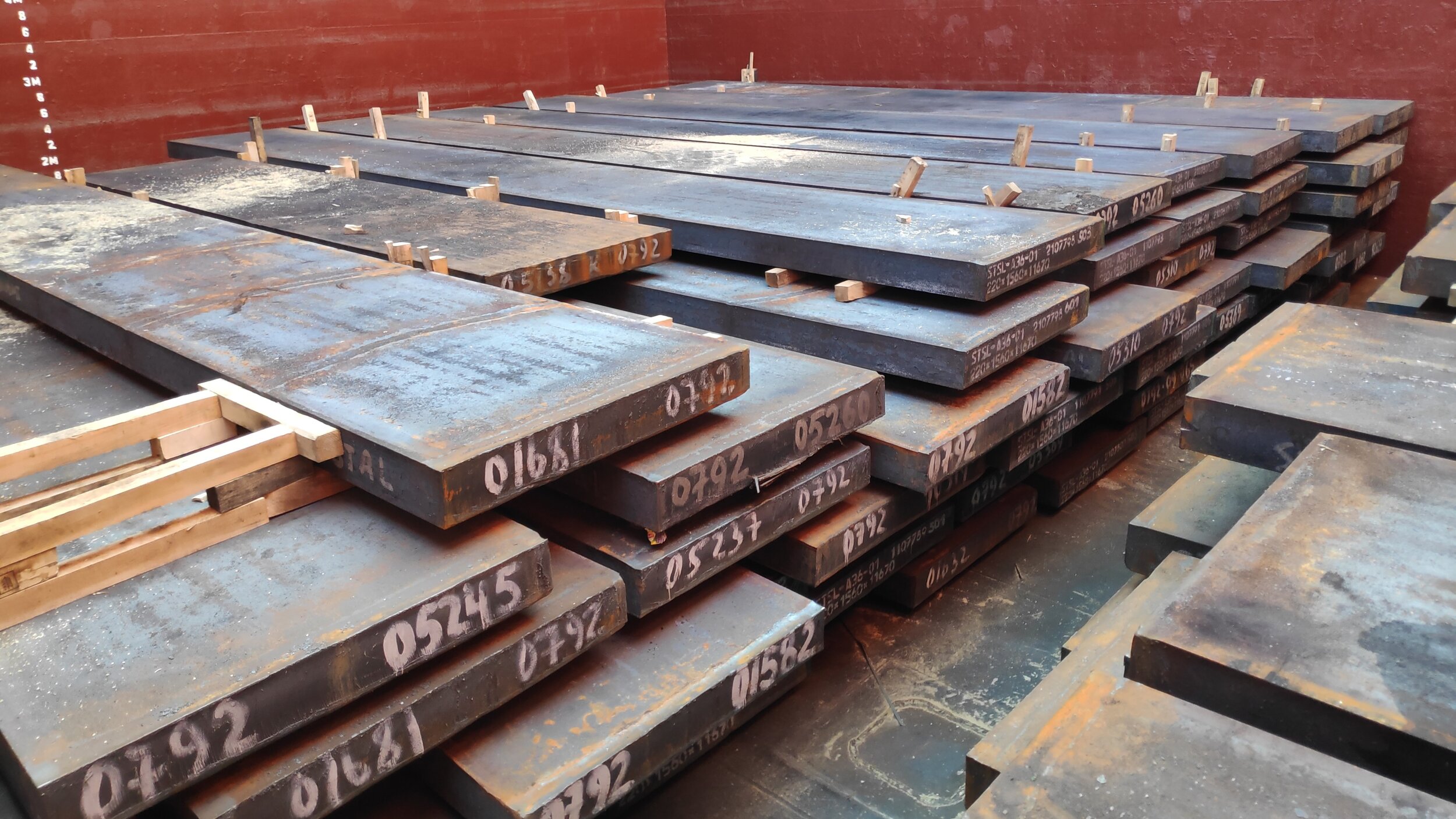 Steel slabs loaded in hold, chocking by timbers of top layer