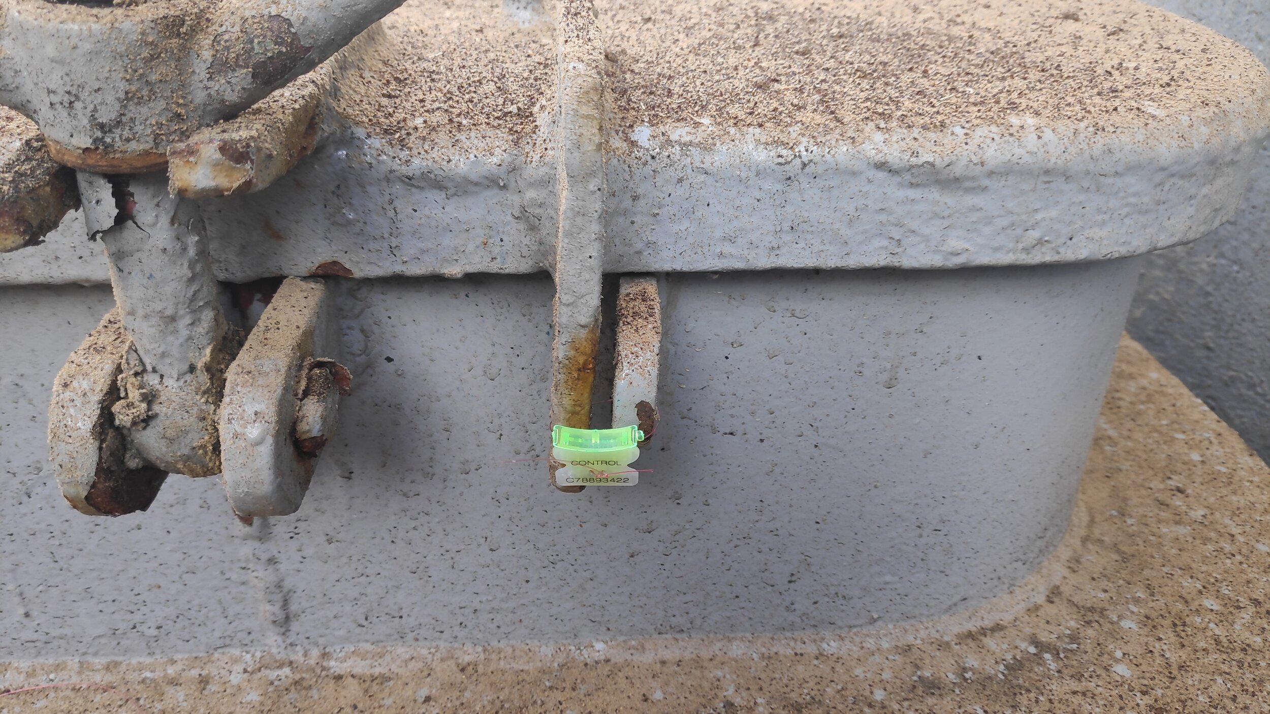 General view of manhole sealed with plastic numbered clip seal