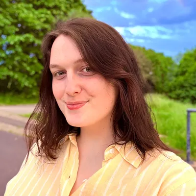 A picture of me smiling on a sunny day in Liverpool