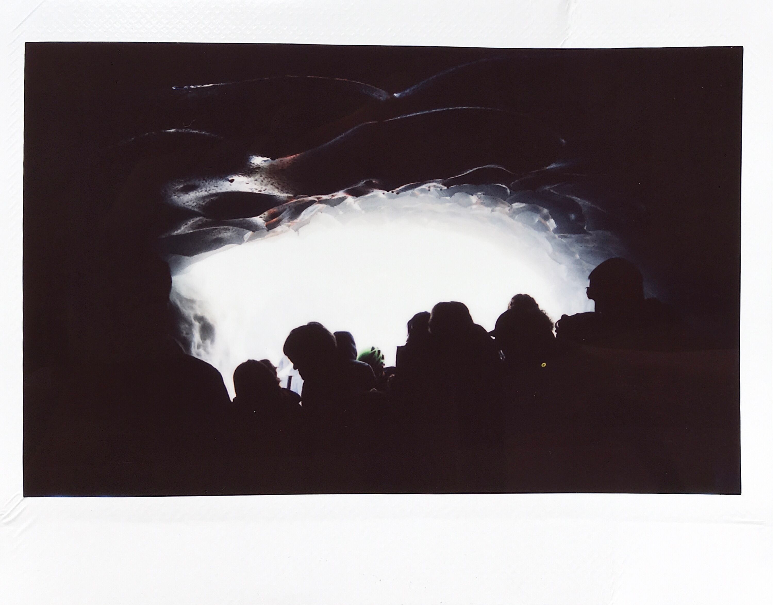 silhouettes of people in a cave