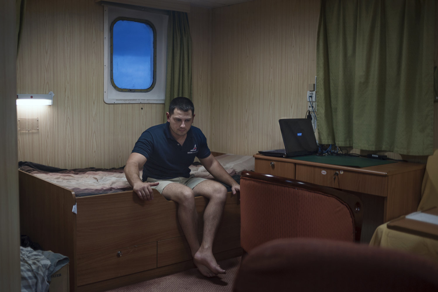 person sitting on a bed on a boat