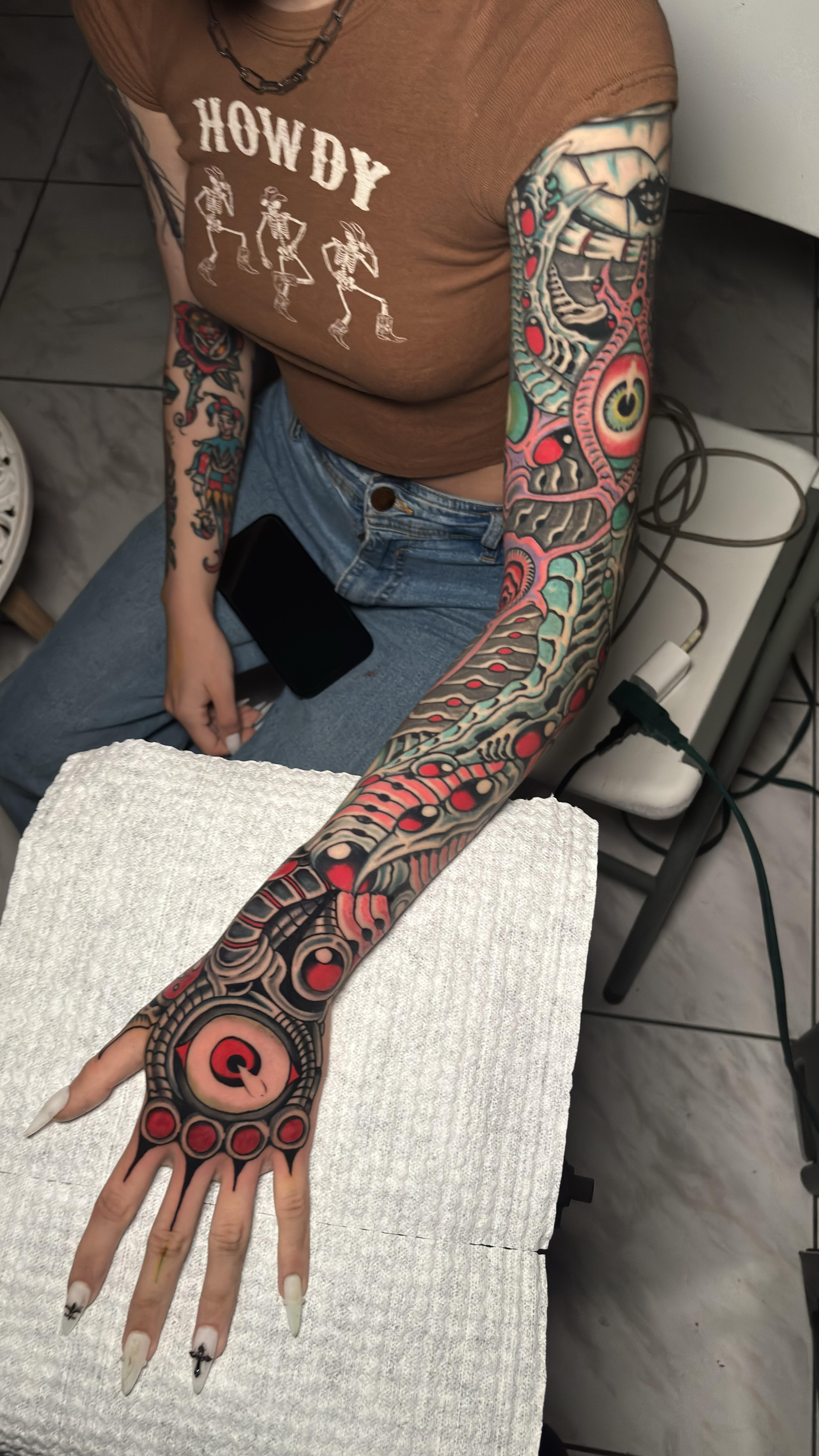 Bold biomechanical sleeve with red orbs and intricate linework