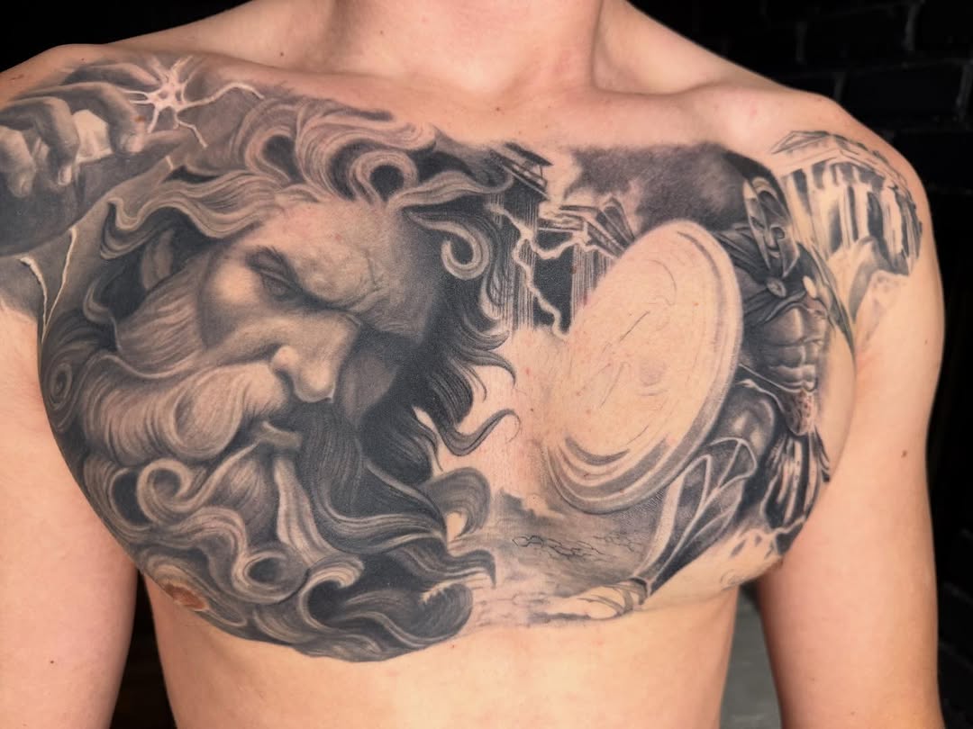 Dramatic black-gray mythic chest piece with flowing hair