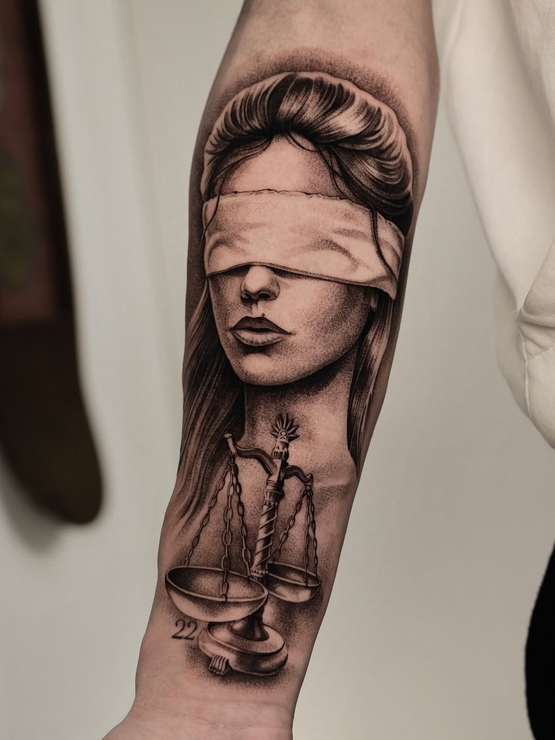 Striking grayscale Lady Justice with blindfold and scales.