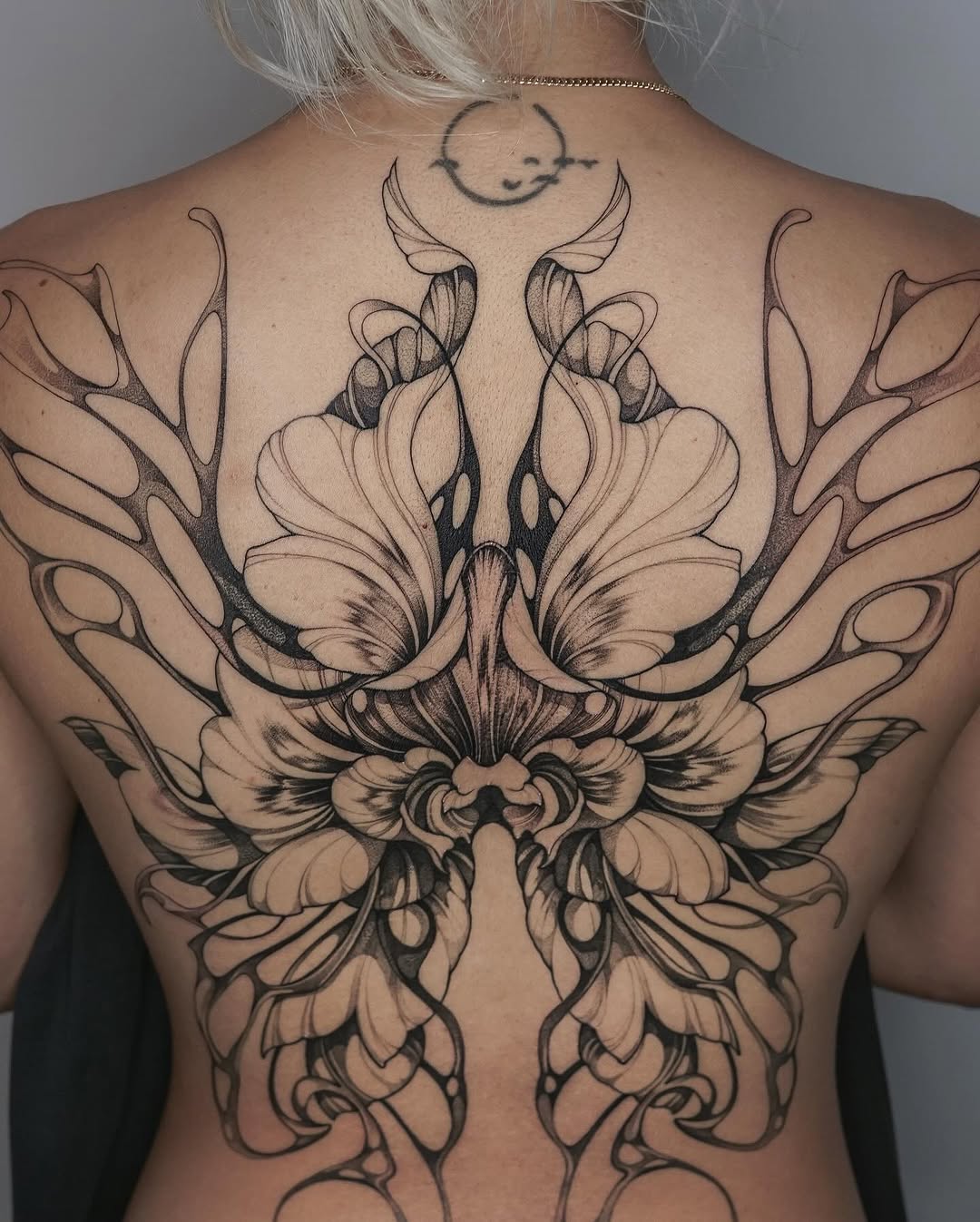 Symmetrical orchid blossoms with flowing linework and moon accent.