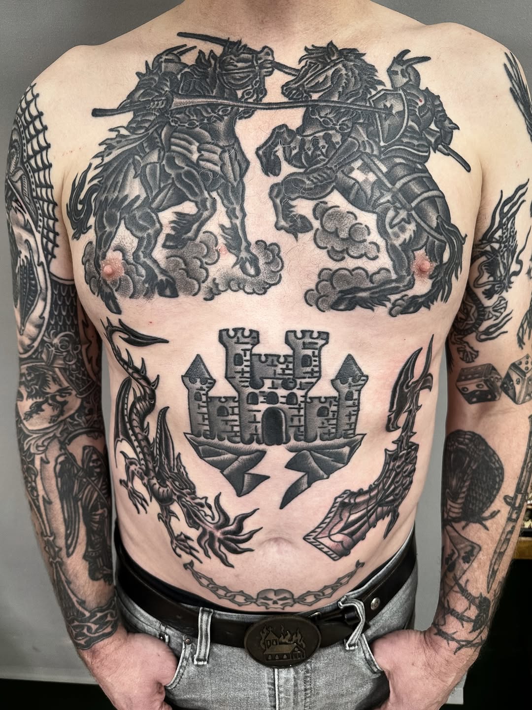 Bold blackwork knights clash above a crenellated castle