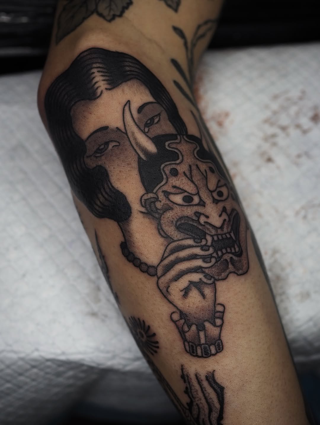 Bold blackwork portrait fusing female profile with demon mask