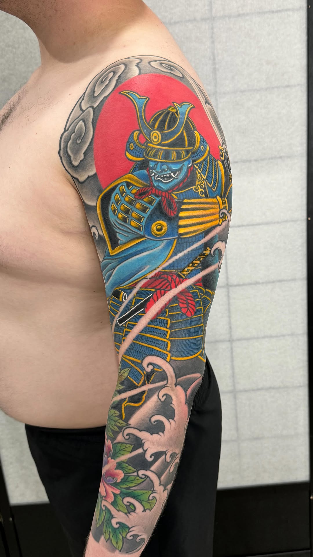 Bold Japanese samurai armor sleeve with sun backdrop