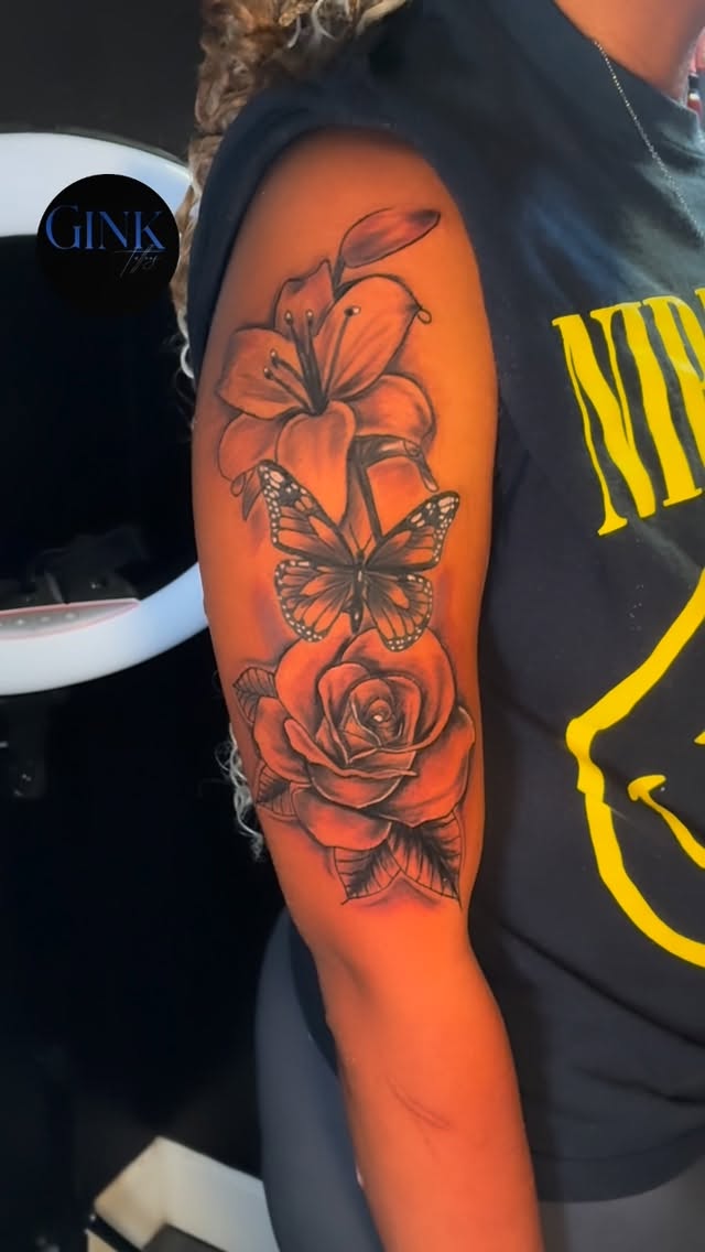 Vibrant floral sleeve featuring lilies, roses, and butterfly.