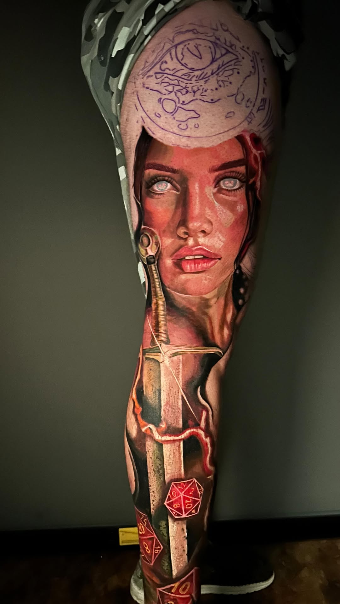 Hyper-realistic female portrait calf sleeve with sword and dice