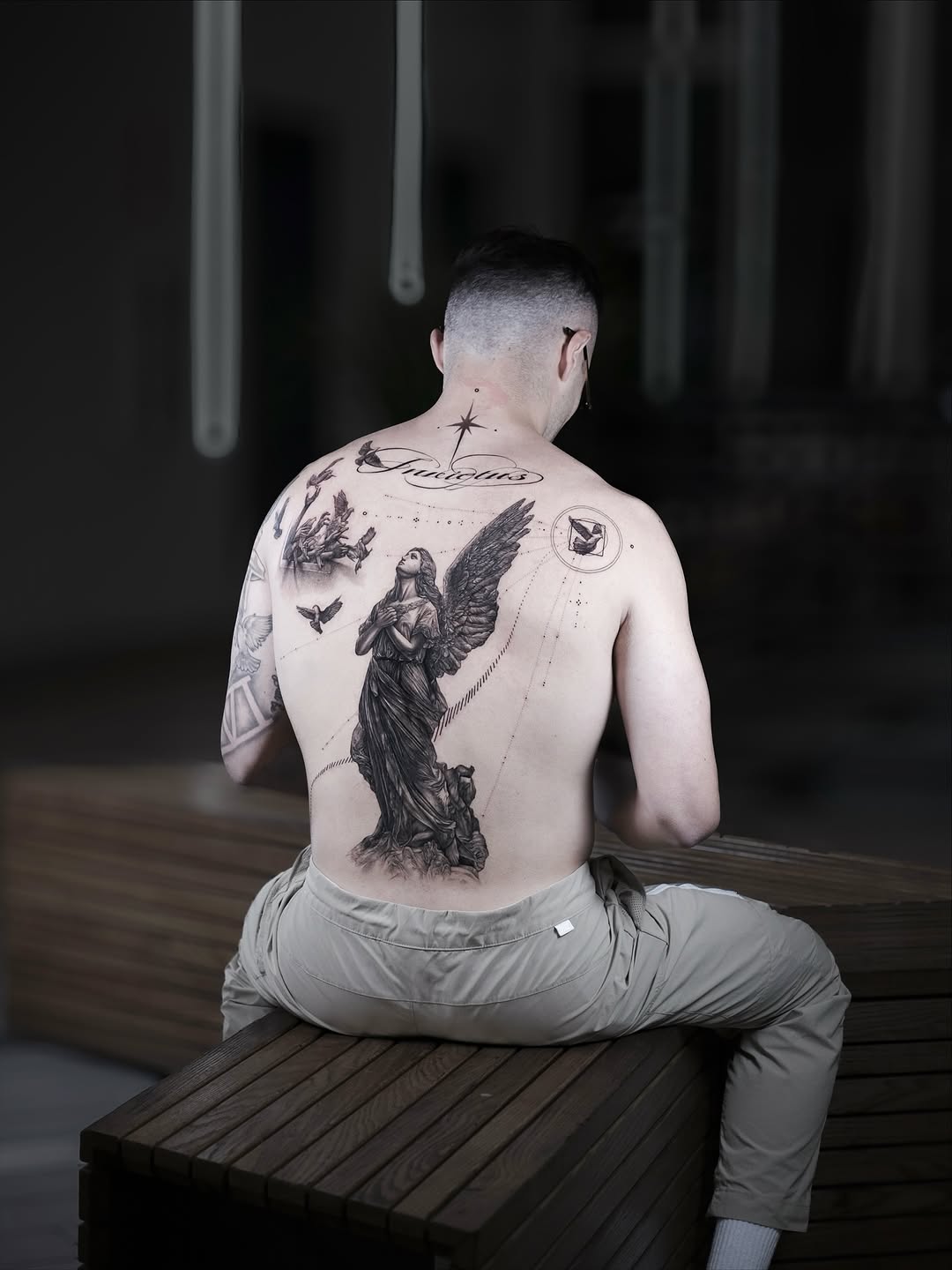 Statue and birds tattoo