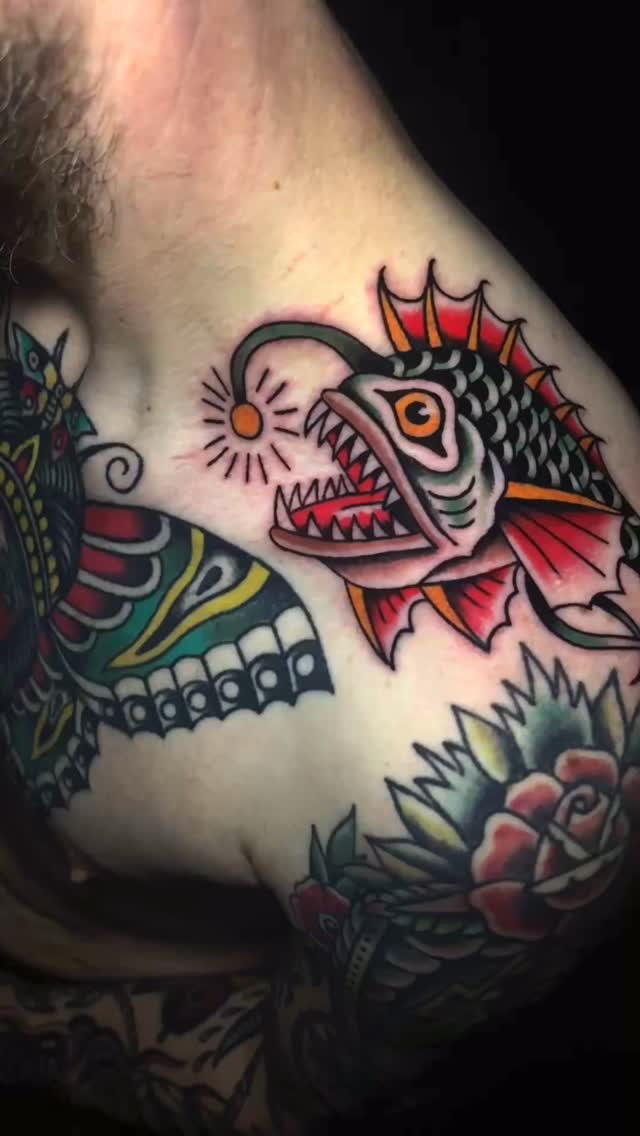 Bold traditional anglerfish with vibrant orange fins.