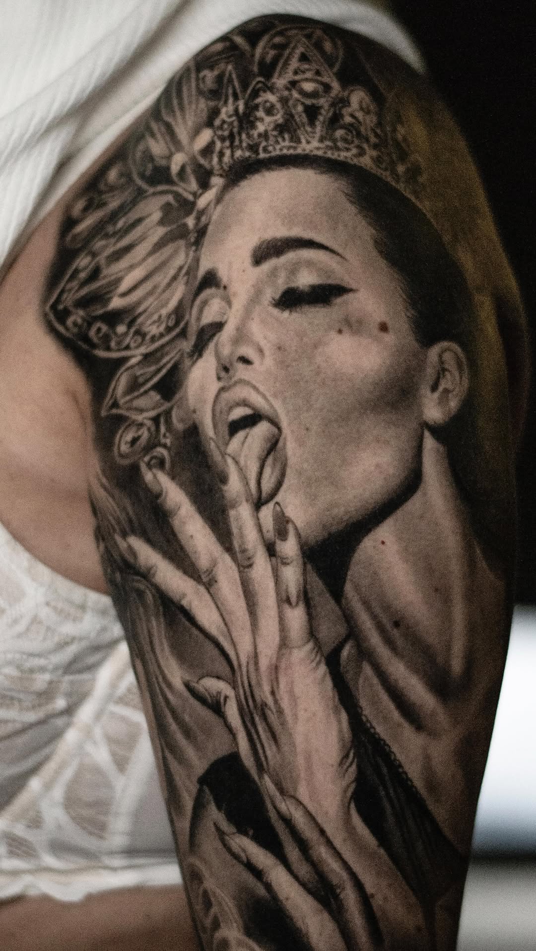 Photorealistic grayscale portrait of a crowned, sultry woman.