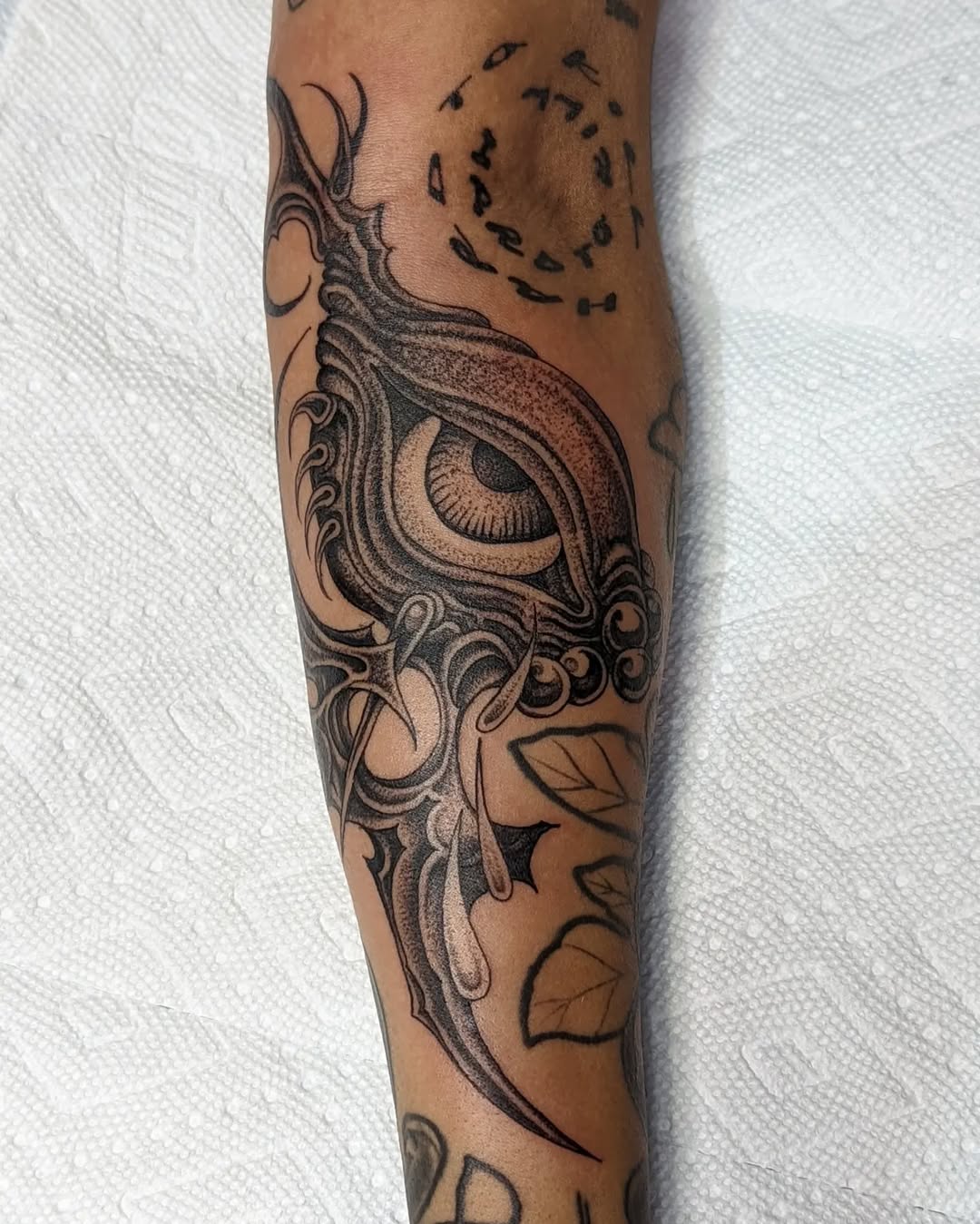 Intricate blackwork eye with flowing ornamental swirls