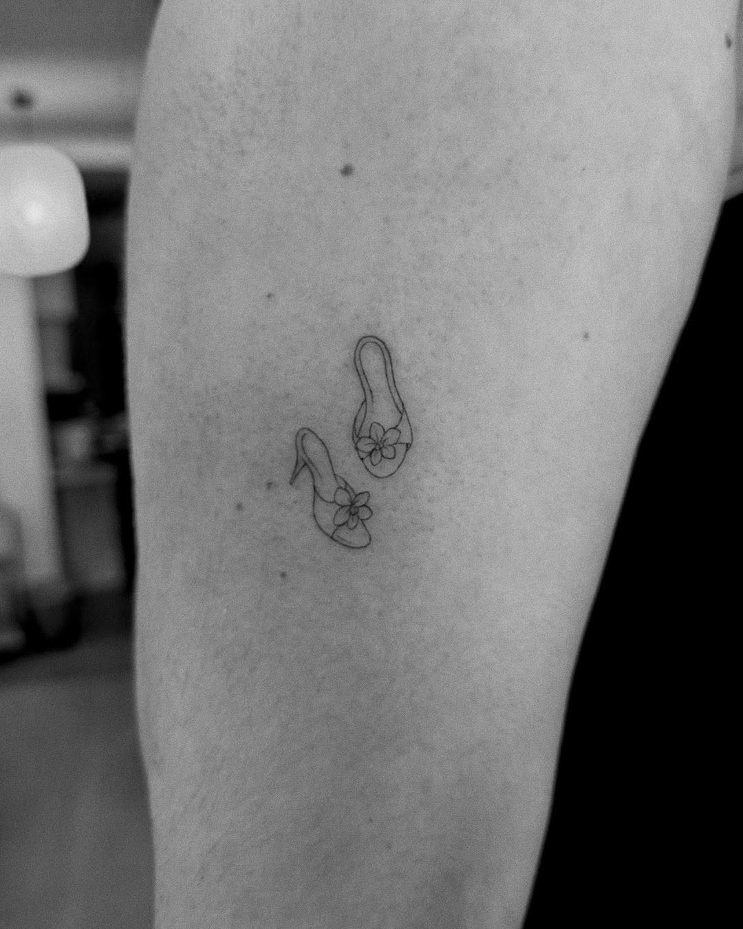 Delicate fine-line flip-flop sandals with floral accent