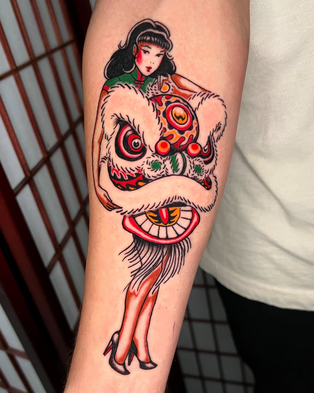 Pinup girl atop a bold, colorful lion-dance mask