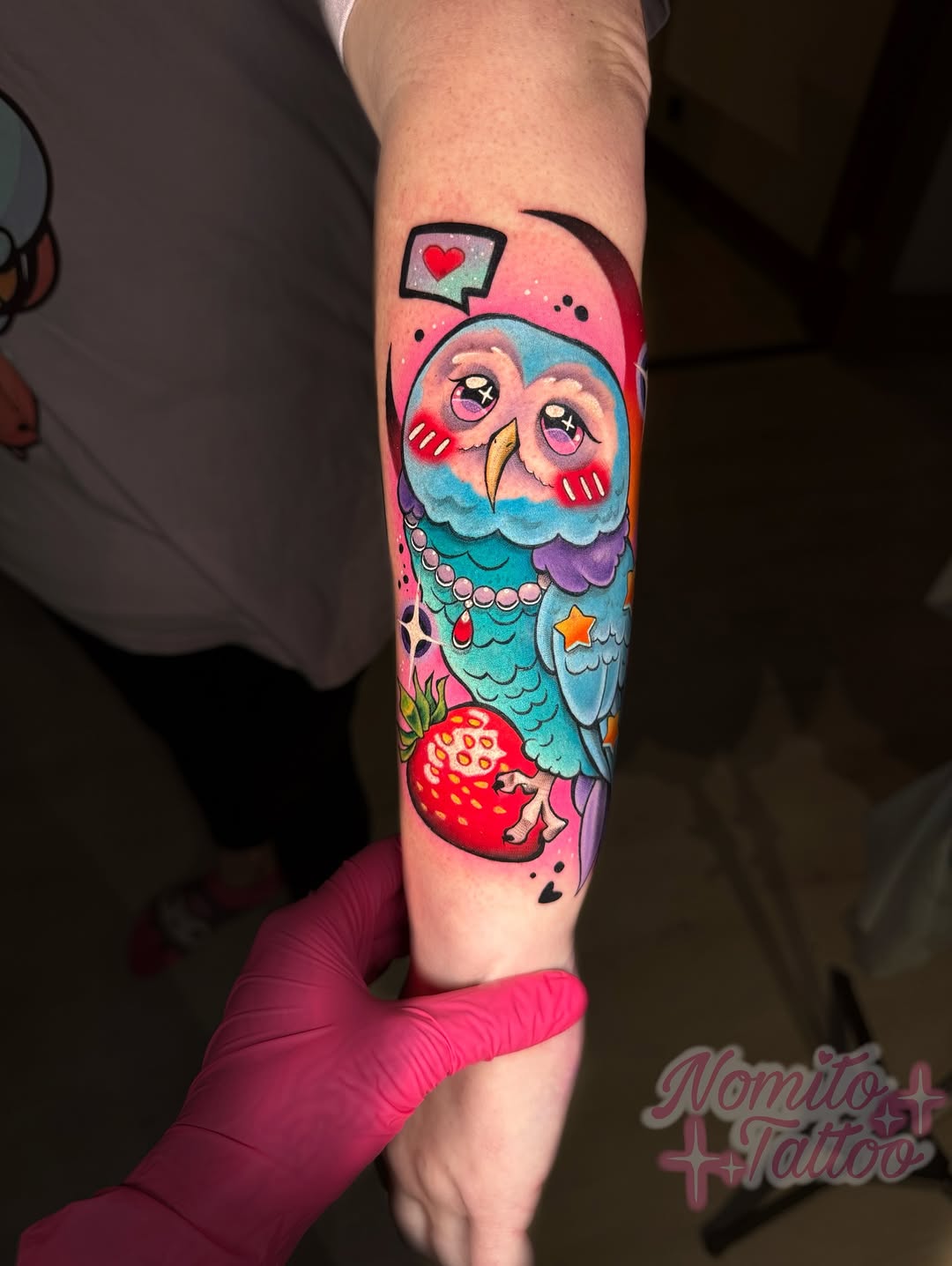 Vibrant kawaii owl with pink backdrop, beads, and strawberry