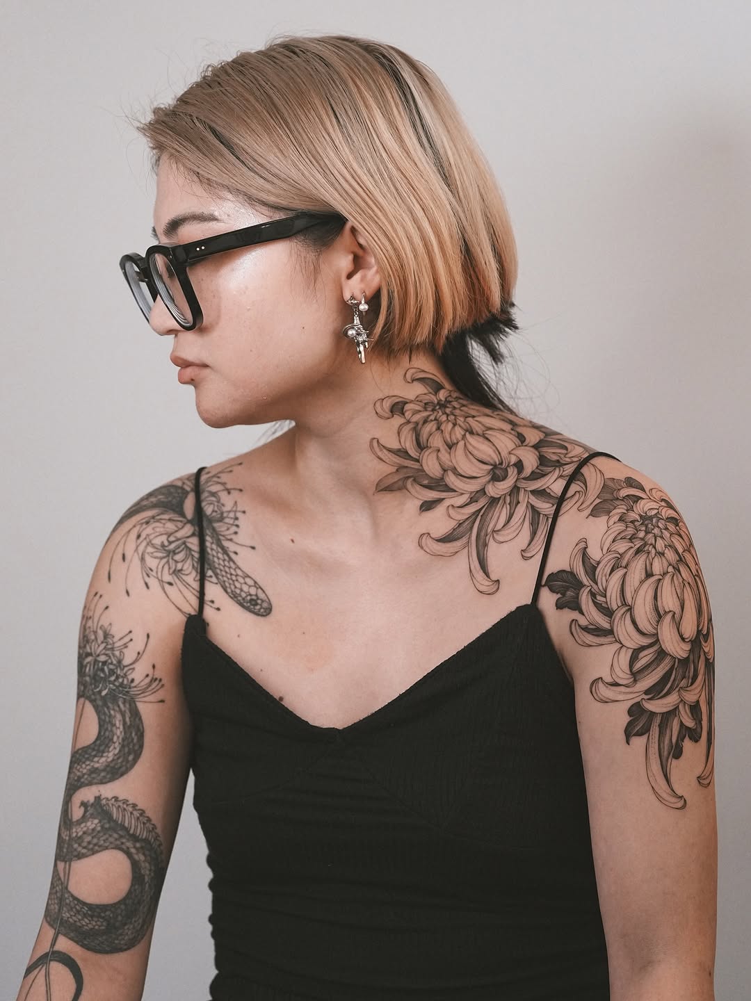 Bold chrysanthemum bouquet across neck and shoulder with dragon