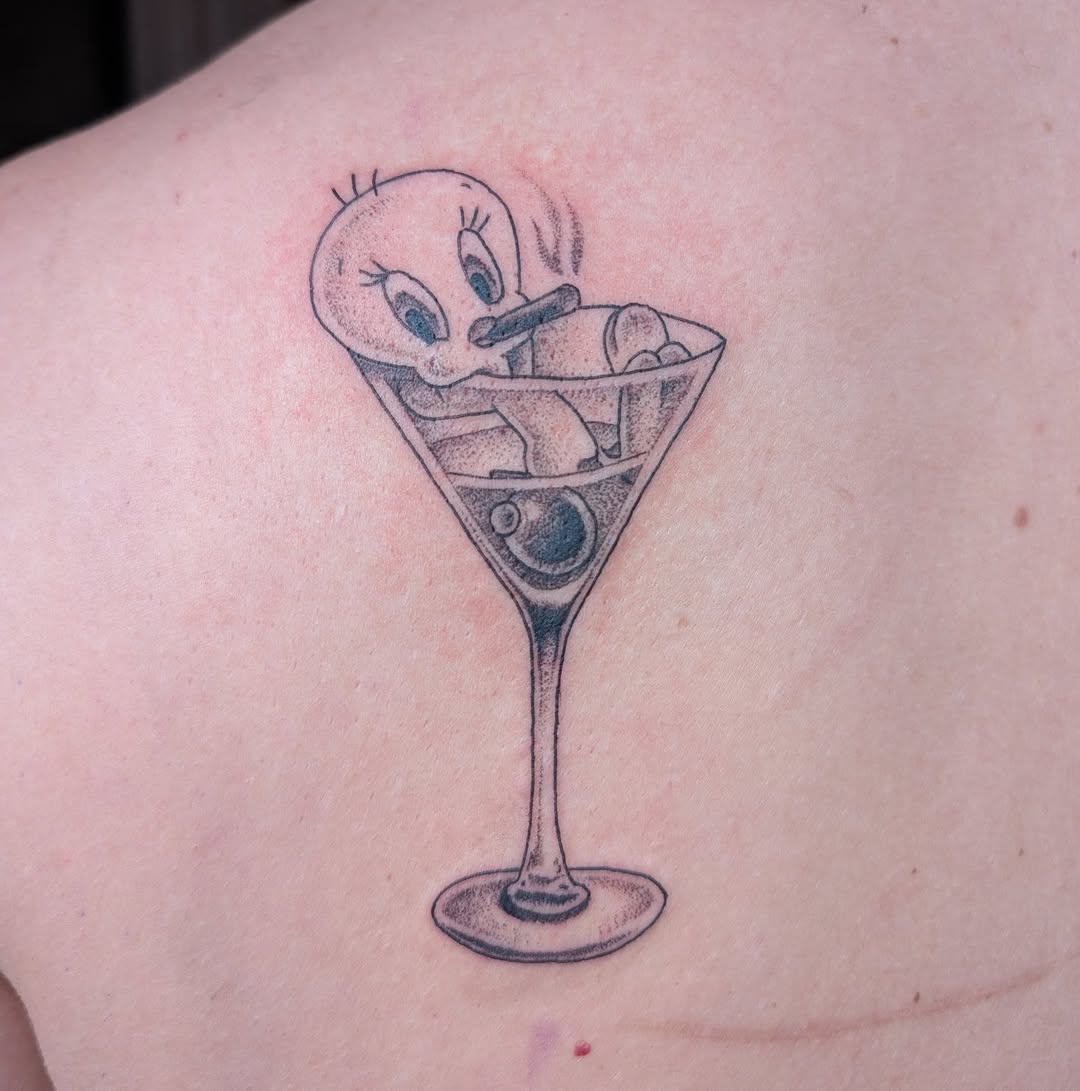 Playful Tweety-style bird perched in a martini glass