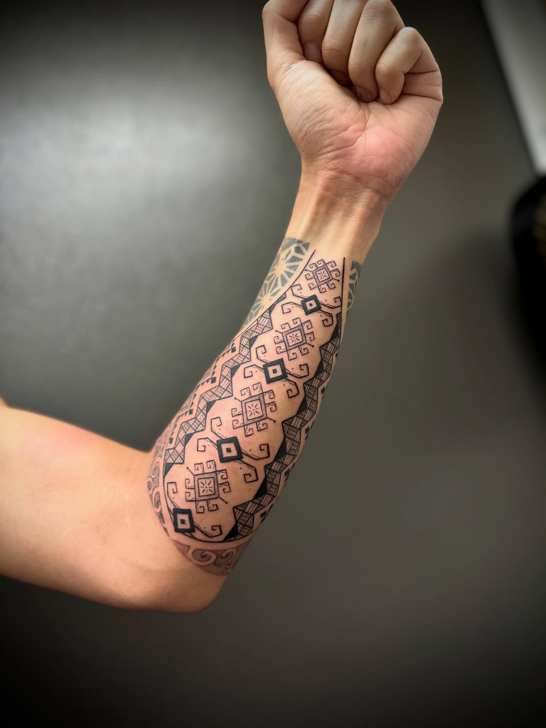 Intricate blackwork geometric forearm sleeve with diamonds