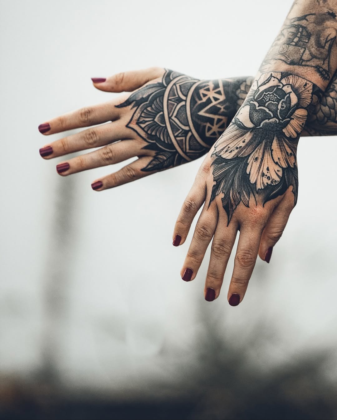 Intricate blackwork hand tattoos with mandala and floral motifs