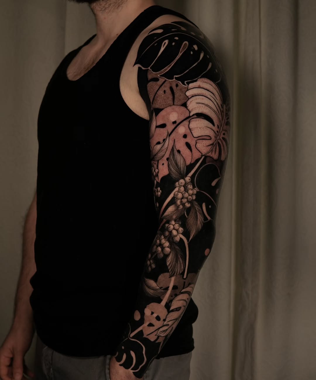 Blackout botanical sleeve tattoo