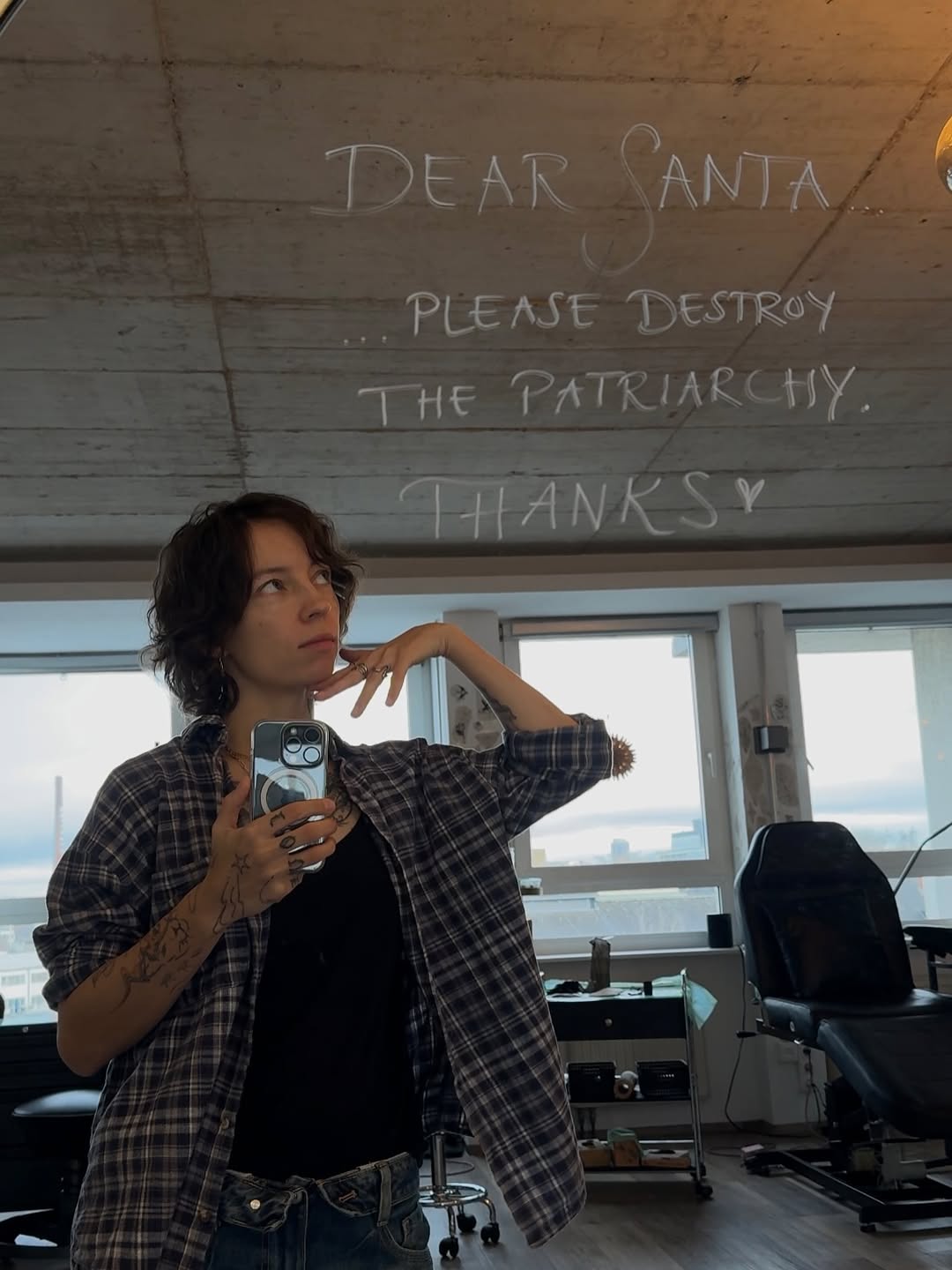 Casual black-line forearm tattoos with geometric floral motifs