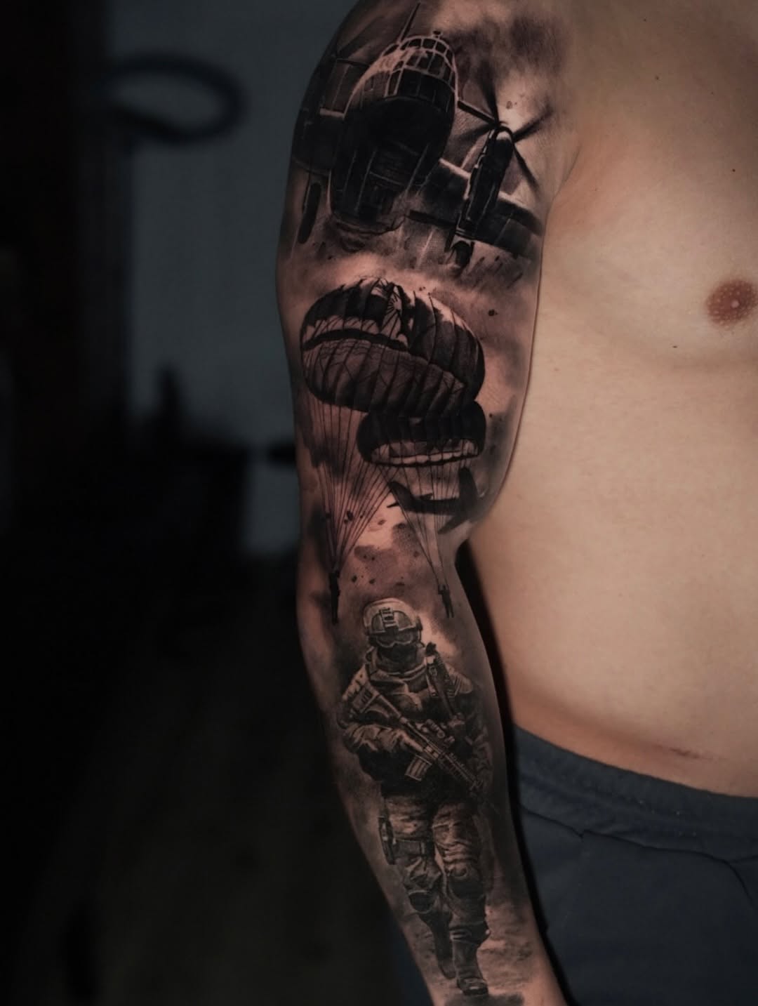 Monochrome military sleeve with parachute drops and infantry