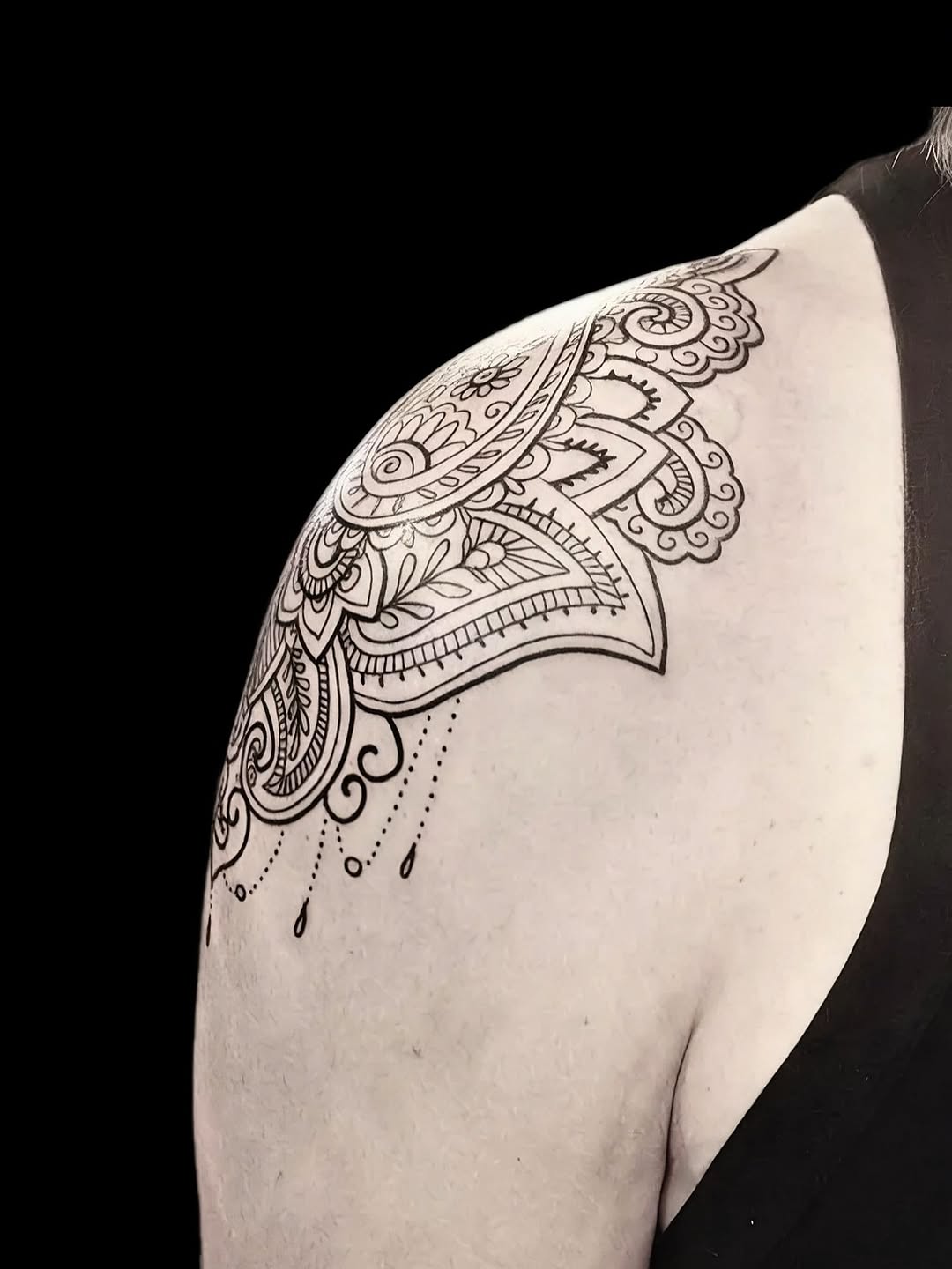 Intricate ornamental shoulder piece with mandala filigree lines.