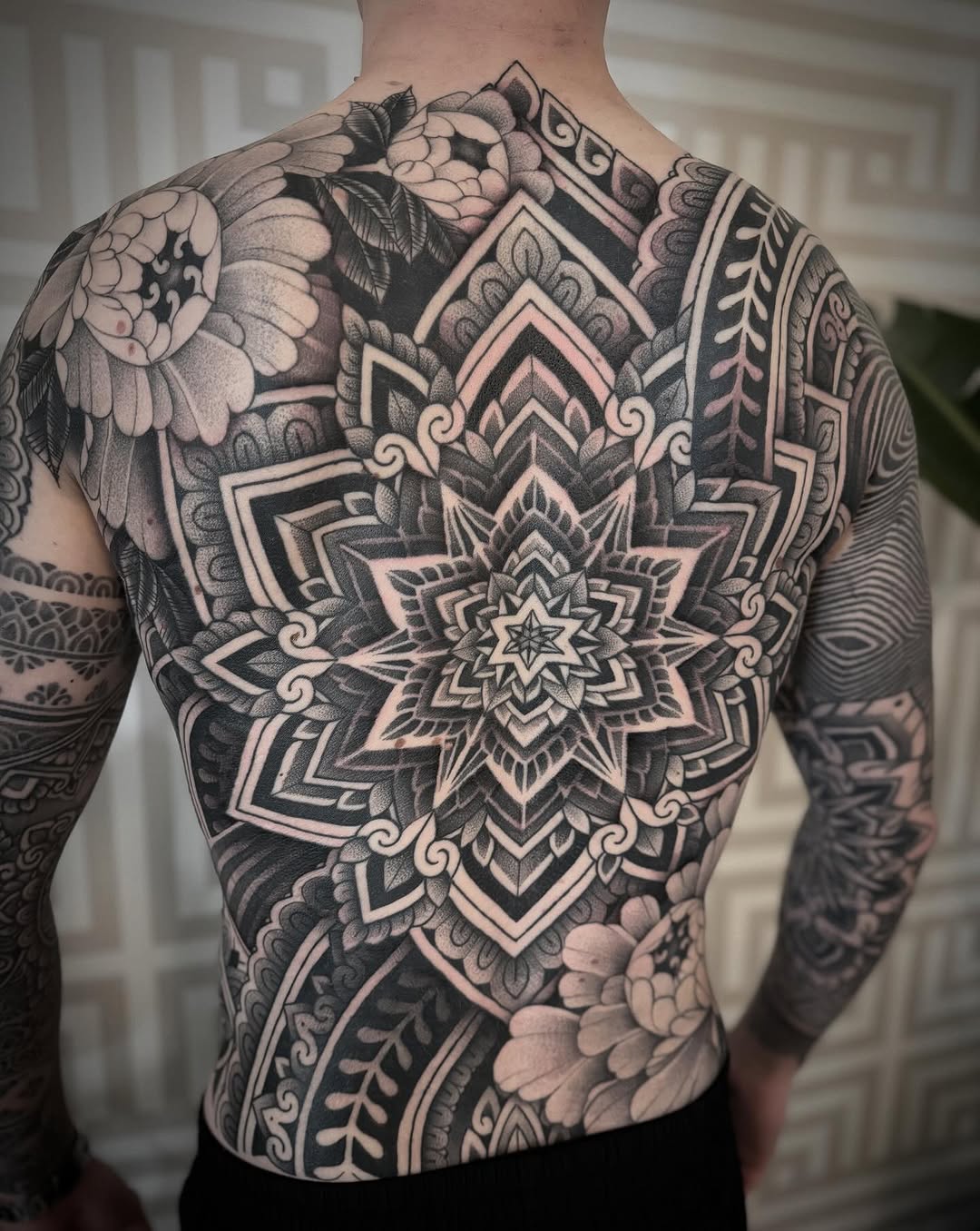 Intricate blackwork mandala back piece with layered geometry