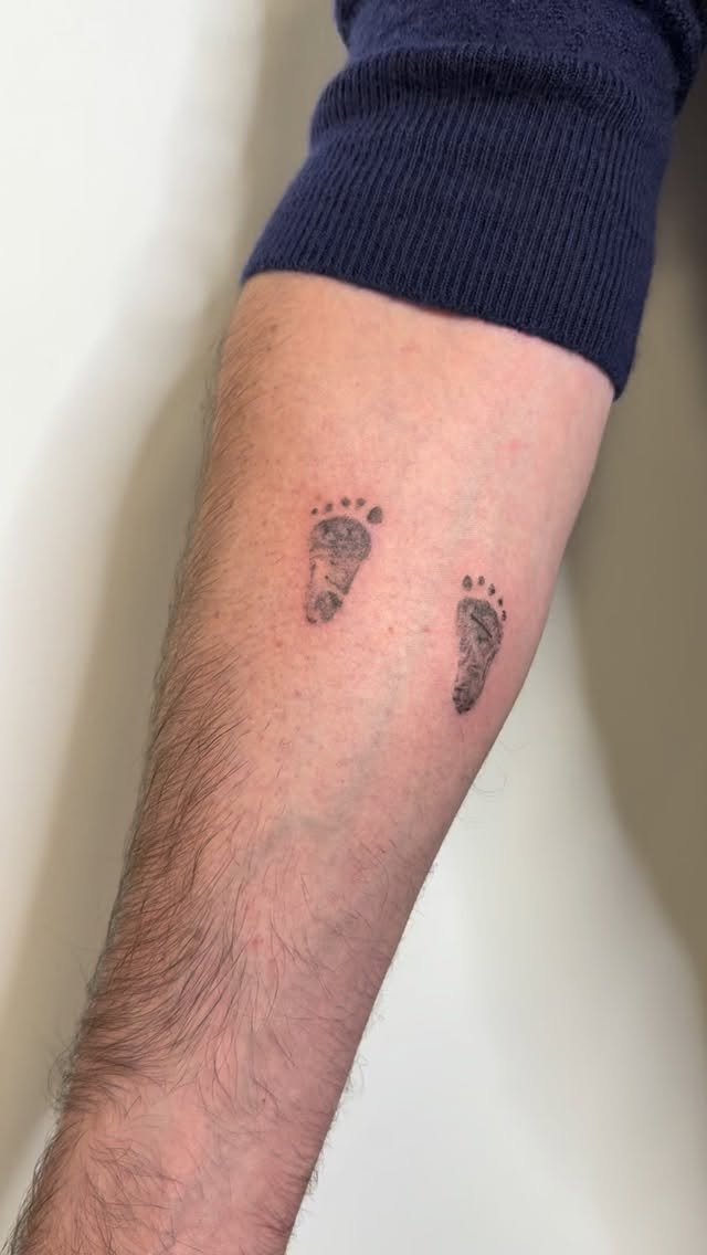 Delicate double baby footprints in clean black ink