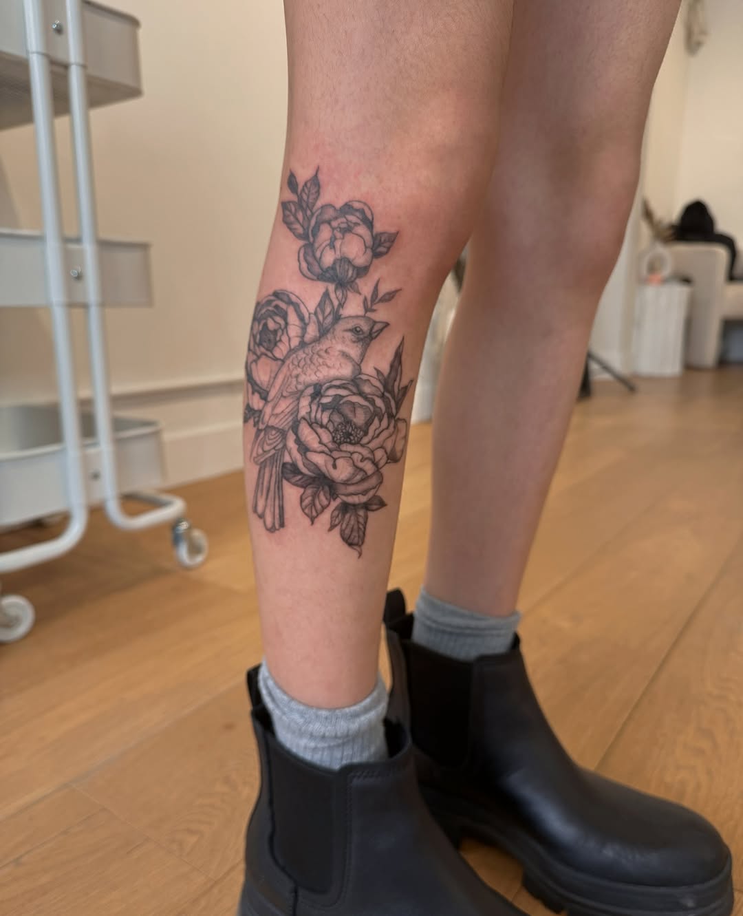 Elegant black-and-gray floral leg piece with perched bird.