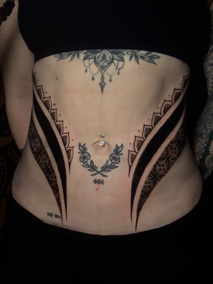 Symmetrical blackwork back piece with serrated panels and laurel
