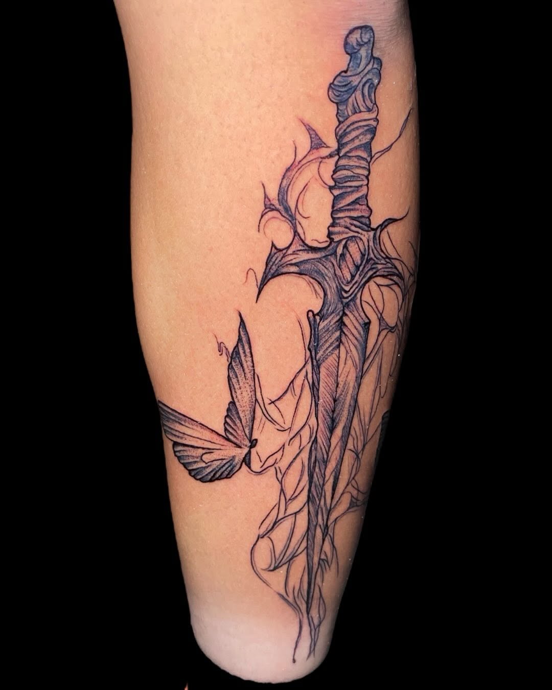 Intricate blackline dagger entwined with thorny vines
