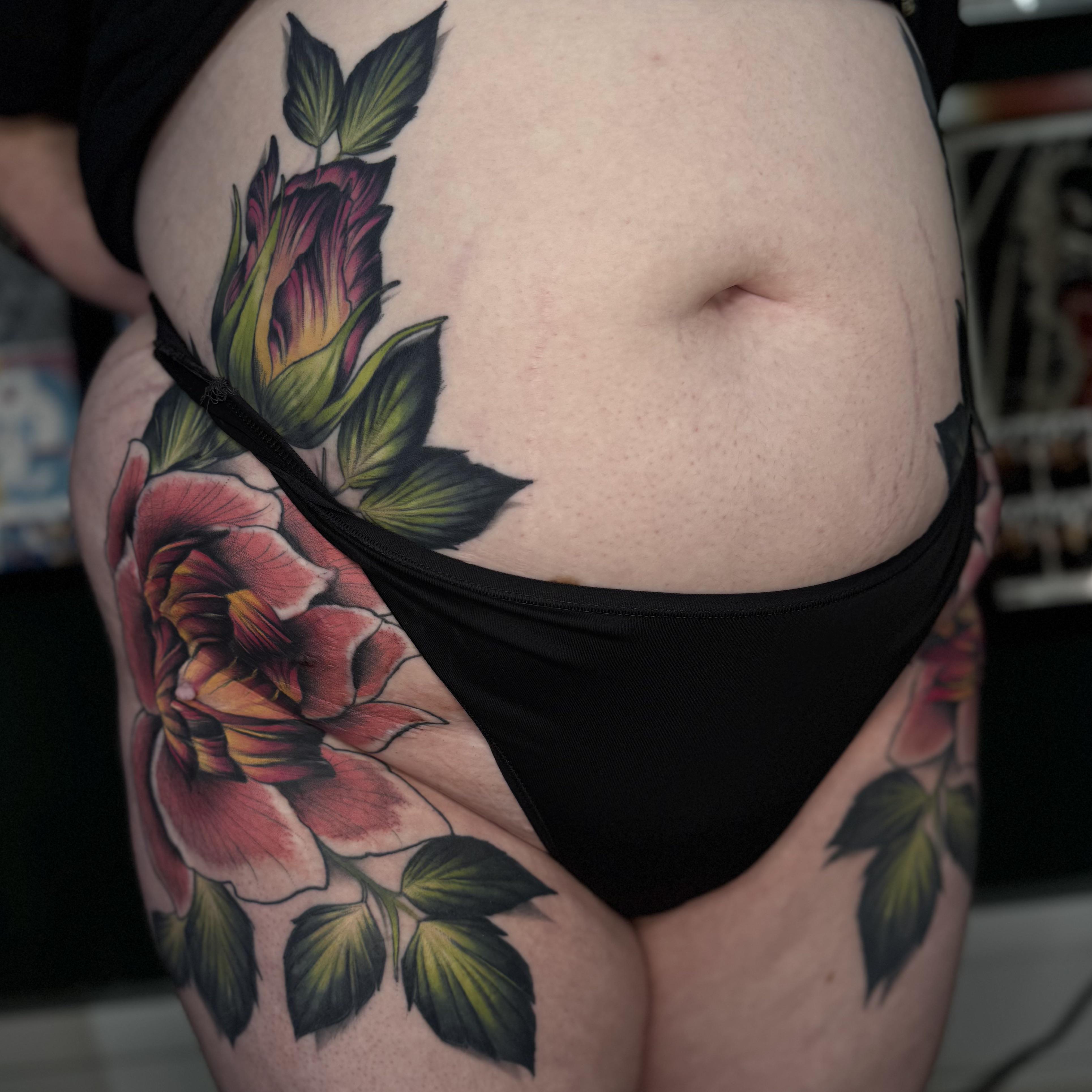 Vibrant neo-traditional pink rose with lush leaves on hip